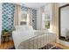 Inviting bedroom with patterned wallpaper, white linens, and natural light, providing a peaceful and comfortable retreat at 2128 Golfview Dr, Charleston, SC 29412