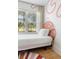 Cozy bedroom with a pink accent wall, single bed and a large window, creating a unique and inviting space at 2128 Golfview Dr, Charleston, SC 29412