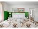 Bright bedroom with a comfortable bed with tropical bedding, bright green wall, and decor at 2128 Golfview Dr, Charleston, SC 29412