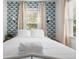 Comfortable bedroom with patterned wallpaper, white linens, and natural light, providing a peaceful retreat at 2128 Golfview Dr, Charleston, SC 29412