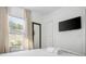 Bright bedroom with large window, sleek mirror, and wall-mounted TV, offering comfort and style at 2128 Golfview Dr, Charleston, SC 29412