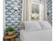Charming bedroom features elegant wallpaper and a comfortable bed with bright natural light at 2128 Golfview Dr, Charleston, SC 29412
