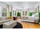Bright bedroom features large windows, comfortable seating area, and charming decor with a tropical theme at 2128 Golfview Dr, Charleston, SC 29412