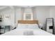 Light-filled bedroom with a plush bed, stylish lamps, and a large window, combining comfort and modern design at 2128 Golfview Dr, Charleston, SC 29412