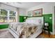 Bright bedroom with a comfortable bed with tropical bedding, bright green wall, and decor at 2128 Golfview Dr, Charleston, SC 29412