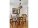 Cozy dining area with seating for four, vintage lighting, and a large mirror creating an open space at 2128 Golfview Dr, Charleston, SC 29412