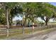 A lovely neighborhood playground surrounded by majestic trees and a rustic wooden fence at 2128 Golfview Dr, Charleston, SC 29412