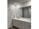 Bright bathroom featuring double sinks with white cabinets and brushed silver hardware at 244 Tuscan Sun St, Summerville, SC 29485