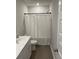 A bathroom with a white vanity, toilet, and a shower with a white curtain at 244 Tuscan Sun St, Summerville, SC 29485