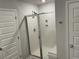 Shower with glass doors in white tiled bathroom with multiple doors at 244 Tuscan Sun St, Summerville, SC 29485