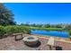 Outdoor seating area with a fire pit overlooking a pond and golf course at 25 Ocean Point Dr, Isle of Palms, SC 29451