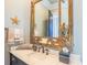 Powder room with decorative mirror, starfish accent and marble countertop with an undermount sink at 25 Ocean Point Dr, Isle of Palms, SC 29451