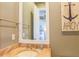 Nautical-themed bathroom featuring granite countertop, decorative mirror and a glimpse into an adjoining bedroom at 25 Ocean Point Dr, Isle of Palms, SC 29451