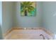 Bathtub framed by tile surround, located beneath a palm tree print at 25 Ocean Point Dr, Isle of Palms, SC 29451
