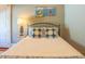 Bedroom with black metal frame bed and nightstand with lamps and beach-themed art at 25 Ocean Point Dr, Isle of Palms, SC 29451