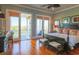 Hardwood floors in a bedroom, as well as access to a porch with seating and a view of the water at 25 Ocean Point Dr, Isle of Palms, SC 29451