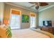 Well-lit bedroom with palm leaf ceiling fan, bamboo shades and patterned throw pillows at 25 Ocean Point Dr, Isle of Palms, SC 29451