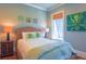 Cozy bedroom featuring a woven headboard, botanical-themed pillows, and art at 25 Ocean Point Dr, Isle of Palms, SC 29451