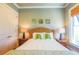 Bedroom with a rattan headboard, two side tables, bamboo window shades, and three botanical wall hangings at 25 Ocean Point Dr, Isle of Palms, SC 29451