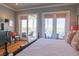 Bright bedroom features hardwood floors, access to a porch, a ceiling fan and a view of the water at 25 Ocean Point Dr, Isle of Palms, SC 29451