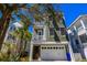 Charming two-story home with a garage and lush landscaping at 25 Ocean Point Dr, Isle of Palms, SC 29451