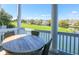 Covered porch with dining table overlooking a scenic view at 25 Ocean Point Dr, Isle of Palms, SC 29451