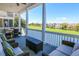 Relaxing covered porch with comfortable seating overlooking a serene golf course at 25 Ocean Point Dr, Isle of Palms, SC 29451