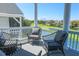Outdoor seating on a porch overlooking a pond and golf course at 25 Ocean Point Dr, Isle of Palms, SC 29451