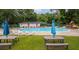 Well-maintained community pool area with lounge chairs, picnic tables, and lush green surroundings at 2864 Wofford Rd, Charleston, SC 29414