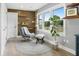 Cozy sitting room with stylish decor, natural light, and a comfortable chair and ottoman at 2864 Wofford Rd, Charleston, SC 29414