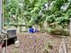 This backyard features a wooden fence, an air conditioner, and lots of trees at 3 Hanover St, Charleston, SC 29403