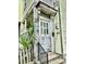Entryway with decorative columns and a weathered, character-rich front door at 3 Hanover St, Charleston, SC 29403
