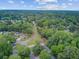 Wide aerial perspective of a charming neighborhood enveloped by beautiful, mature green trees and homes at 300 Hamlet Rd, Summerville, SC 29485