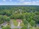 Aerial view of a lush neighborhood, showcasing single-Gathering homes surrounded by beautiful trees and landscaping at 300 Hamlet Rd, Summerville, SC 29485