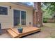 Cozy back deck leading to the backyard, complete with a sliding glass door and a chimney at 300 Hamlet Rd, Summerville, SC 29485