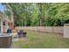 Large fenced backyard with a patio, lounge chairs, barbecue, and a green lawn at 300 Hamlet Rd, Summerville, SC 29485