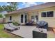 Spacious backyard with a patio, lounge chairs, and a gas grill, perfect for outdoor entertaining at 300 Hamlet Rd, Summerville, SC 29485
