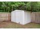 White storage shed with double doors, enclosed by a wooden fence and surrounded by trees at 300 Hamlet Rd, Summerville, SC 29485