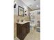 Well-lit bathroom featuring tiled walls, a dark wood vanity, and a coastal shower curtain at 300 Hamlet Rd, Summerville, SC 29485