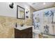 Bright bathroom with a dark vanity, large mirror, and seashell-themed shower curtain at 300 Hamlet Rd, Summerville, SC 29485
