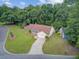 Attractive single-Gathering home showcasing green lawn, lush trees, and a driveway accessing a garage at 300 Hamlet Rd, Summerville, SC 29485