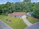 Charming single-Gathering home featuring a well-manicured lawn, mature trees, and a long driveway leading to a garage at 300 Hamlet Rd, Summerville, SC 29485