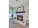 Bright fireplace with mantle decor, adjacent windows, and neutral walls at 300 Hamlet Rd, Summerville, SC 29485