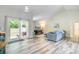 Bright living room with sliding glass doors, modern flooring, and a cozy fireplace with a TV above at 300 Hamlet Rd, Summerville, SC 29485