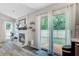 Cozy living room featuring a brick fireplace and sliding glass doors leading to the wooden deck at 300 Hamlet Rd, Summerville, SC 29485