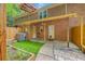 View of brick townhome with patio, small garden, and partial fence providing a cozy outdoor space at 302 Springview Ln # 10, Summerville, SC 29485
