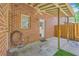 View of the covered patio with ceiling fan, door to the home, and a brick exterior for outdoor comfort at 302 Springview Ln # 10, Summerville, SC 29485