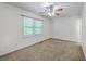 Carpeted bedroom with a ceiling fan and bright natural light from the window at 302 Springview Ln # 10, Summerville, SC 29485