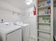 Convenient laundry room featuring washer, dryer, shelving, and storage space at 302 Springview Ln # 10, Summerville, SC 29485