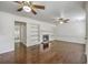 Living room with hardwood floors, fireplace, built-in shelves, and open doorway at 302 Springview Ln # 10, Summerville, SC 29485